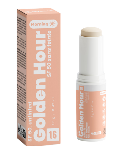 Packshot de Golden Hour n°16 de Luminesse Paris avec son étui pêche et son stick solaire SPF 50 sans teinte de 12 g. Le produit est présenté ouvert avec le stick beige visible, à côté de sa boîte ; la mention Morning et les huiles de riz, tournesol et jojoba figurent sur le packaging.