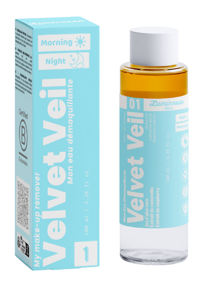 Packshot de Velvet Veil n°01 de Luminesse Paris avec son étui turquoise et son flacon biphasé de 100 ml. La boîte et le flacon sont présentés côte à côte sur fond transparent ; la phase ambrée est visible dans le flacon, avec les mentions Morning, Night, aloe vera, camomille et framboise sur le packaging.